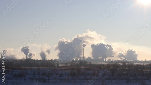 View of chemical manufacturing plants. Heavy emissions from the production pipes of the plant. Pillars of smoke. The concept of air pollution and the natural environment.