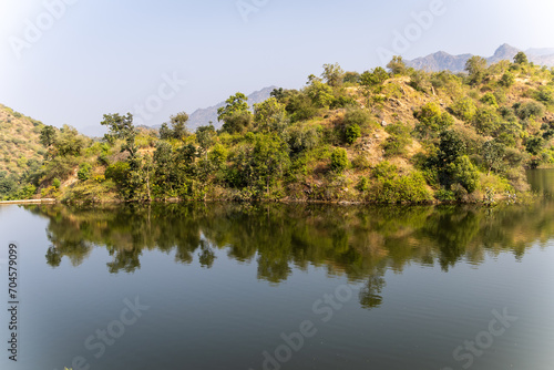 pristine lake with mountain forest reflection at day from different angle