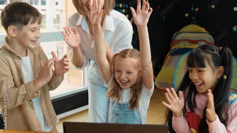 Caucasian teacher and happy students clapping hands to celebrate ...