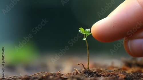 A tiny sprout sitting on the tip of the finger, macro shot, miniaturecore, natural phenomena