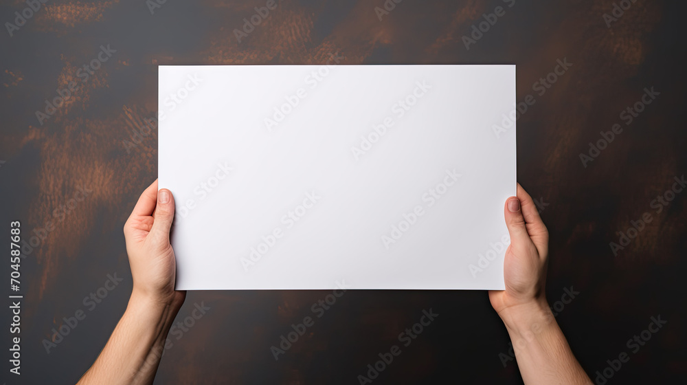 Hands Holding a Blank White Paper Sheet on a Rustic Dark Brown Background Hands Holding a Blank White Paper Sheet on a Rustic Dark Brown Background