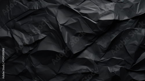 Black creased crumpled paper background grunge texture backdrop. photo