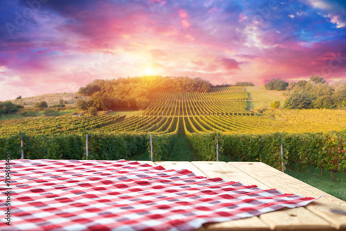The empty wooden table top with blur background of vineyard. Exuberant image. High quality photo