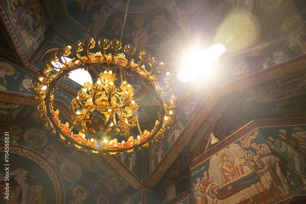 SOFIA, BULGARIA - 30 JULY 2023: Sunlight shine through church ceiling Beautiful colorful Orthodox Church and chandelier