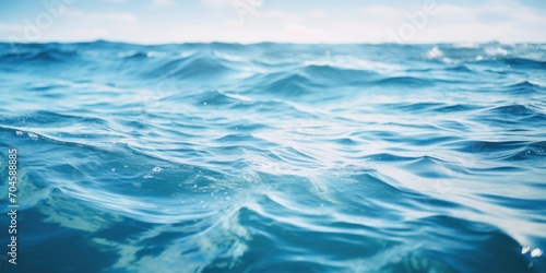 A calm, clear blue ocean surface with gentle waves, embodying purity and tranquility.