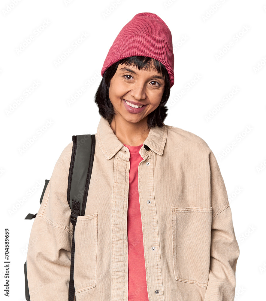 Young student with backpack and beanie in studio excited keeping ok gesture on eye. Young student with backpack and beanie in studio excited keeping ok gesture on eye.