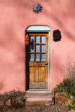 a wooden door on an adobe house in the southwest United States