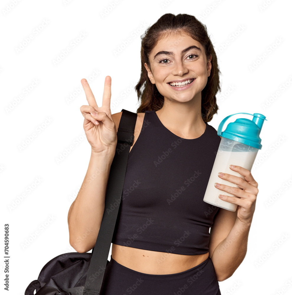 Athletic Caucasian woman holding protein shake showing number two with fingers. Athletic Caucasian woman holding protein shake showing number two with fingers.