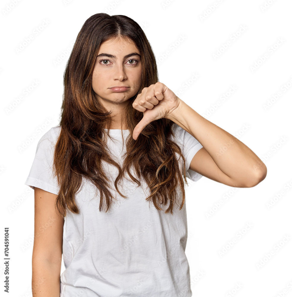Young Caucasian woman in studio setting showing a dislike gesture, thumbs down. Disagreement concept. Young Caucasian woman in studio setting showing a dislike gesture, thumbs down. Disagreement concept.