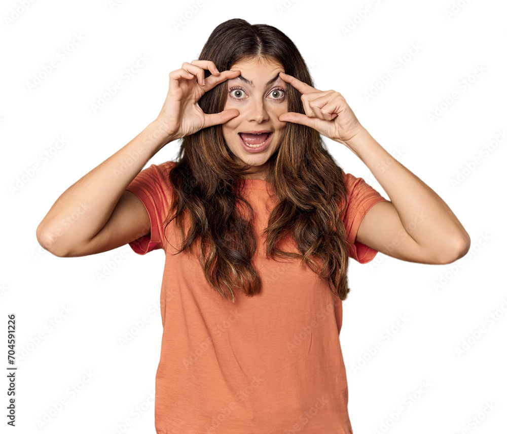 Young Caucasian woman in studio setting keeping eyes opened to find a success opportunity. Young Caucasian woman in studio setting keeping eyes opened to find a success opportunity.