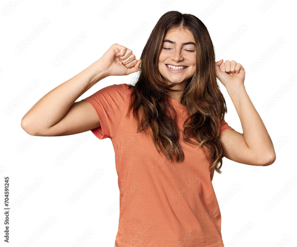 Young Caucasian woman in studio setting celebrating a special day, jumps and raise arms with energy. Young Caucasian woman in studio setting celebrating a special day, jumps and raise arms with energy.
