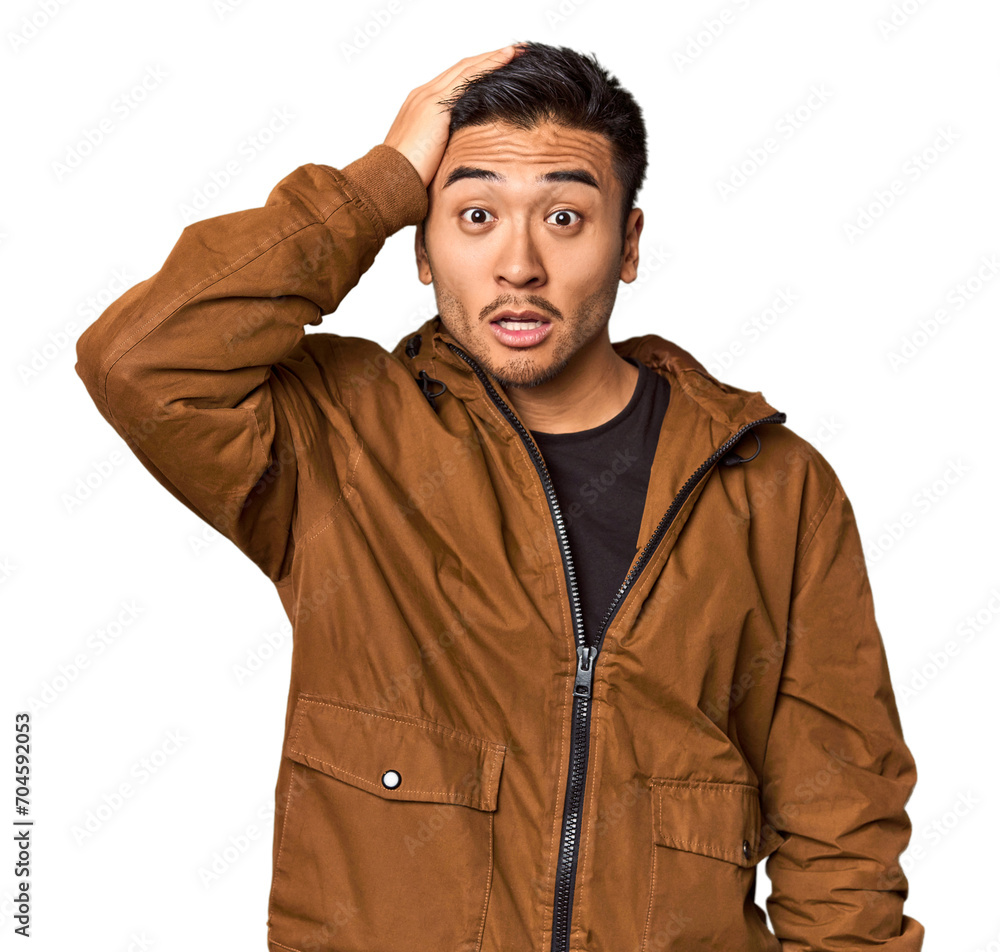 Young Chinese man in studio background being shocked, she has remembered important meeting. Young Chinese man in studio background being shocked, she has remembered important meeting.