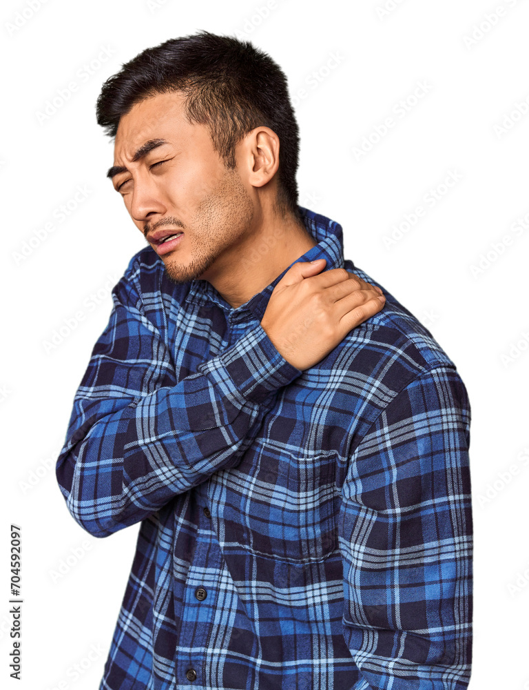 Young Chinese man in studio background having a shoulder pain. Young Chinese man in studio background having a shoulder pain.