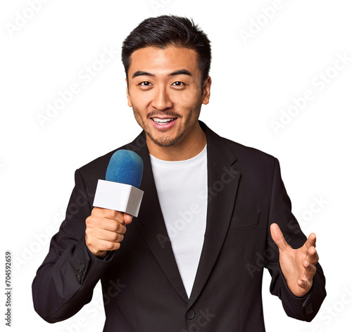 Foto Young Chinese TV presenter reporting news with microphone in studio