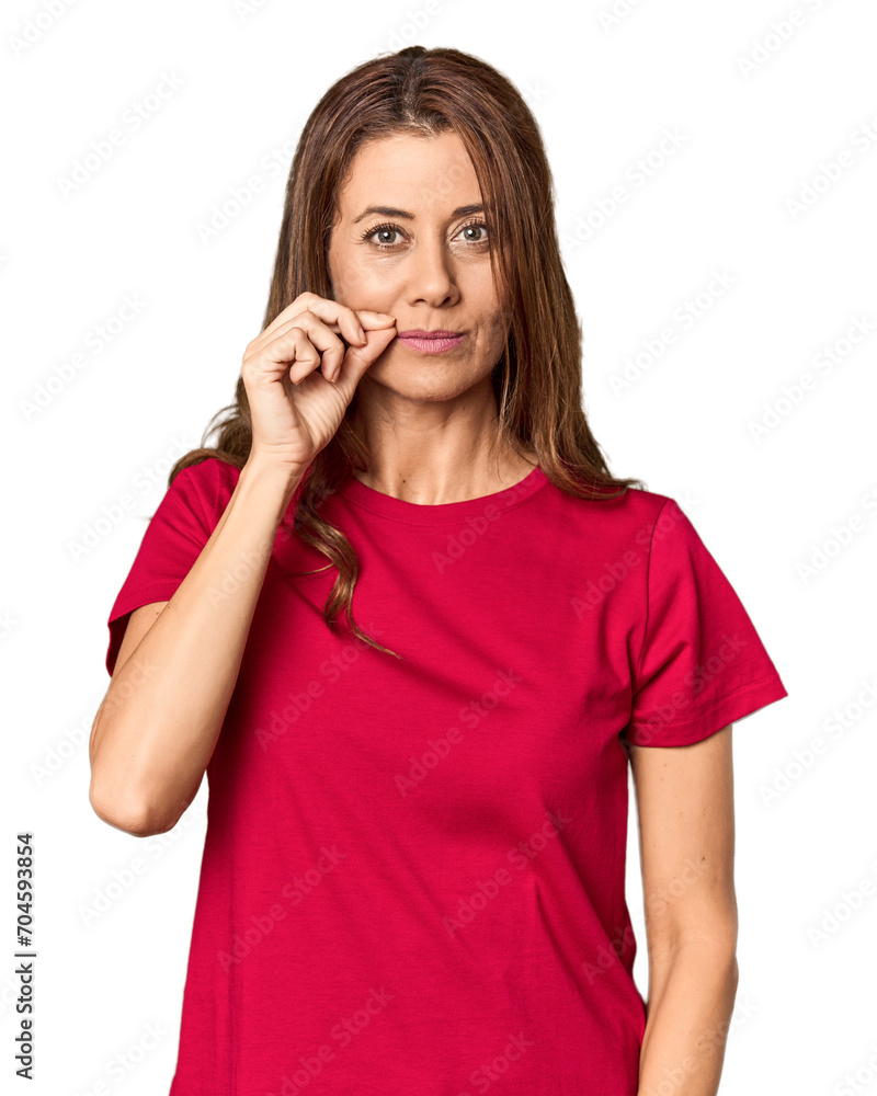 Middle-aged woman portrait in studio setting with fingers on lips keeping a secret. Middle-aged woman portrait in studio setting with fingers on lips keeping a secret.