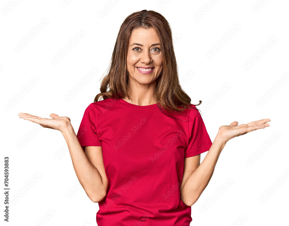 Middle-aged woman portrait in studio setting makes scale with arms, feels happy and confident. Middle-aged woman portrait in studio setting makes scale with arms, feels happy and confident.