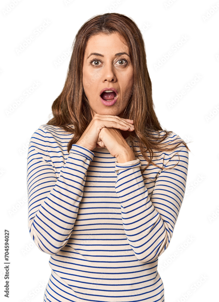 Middle-aged woman portrait in studio setting praying for luck, amazed and opening mouth looking to front. Middle-aged woman portrait in studio setting praying for luck, amazed and opening mouth looking to front.