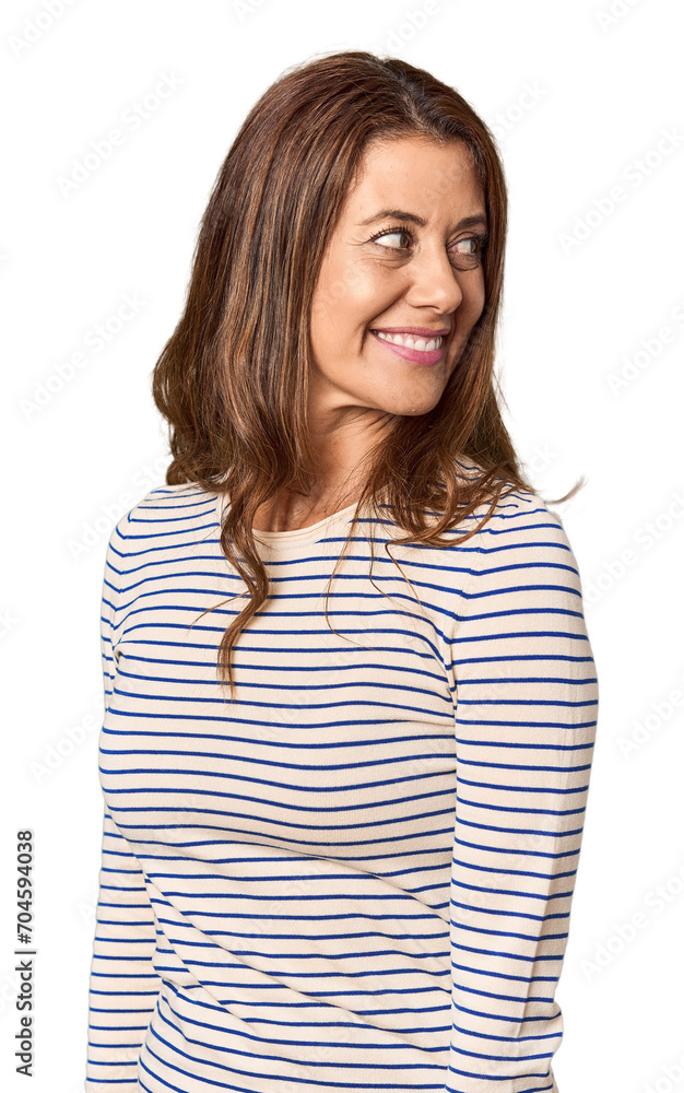 Middle-aged woman portrait in studio setting looks aside smiling, cheerful and pleasant. Middle-aged woman portrait in studio setting looks aside smiling, cheerful and pleasant.