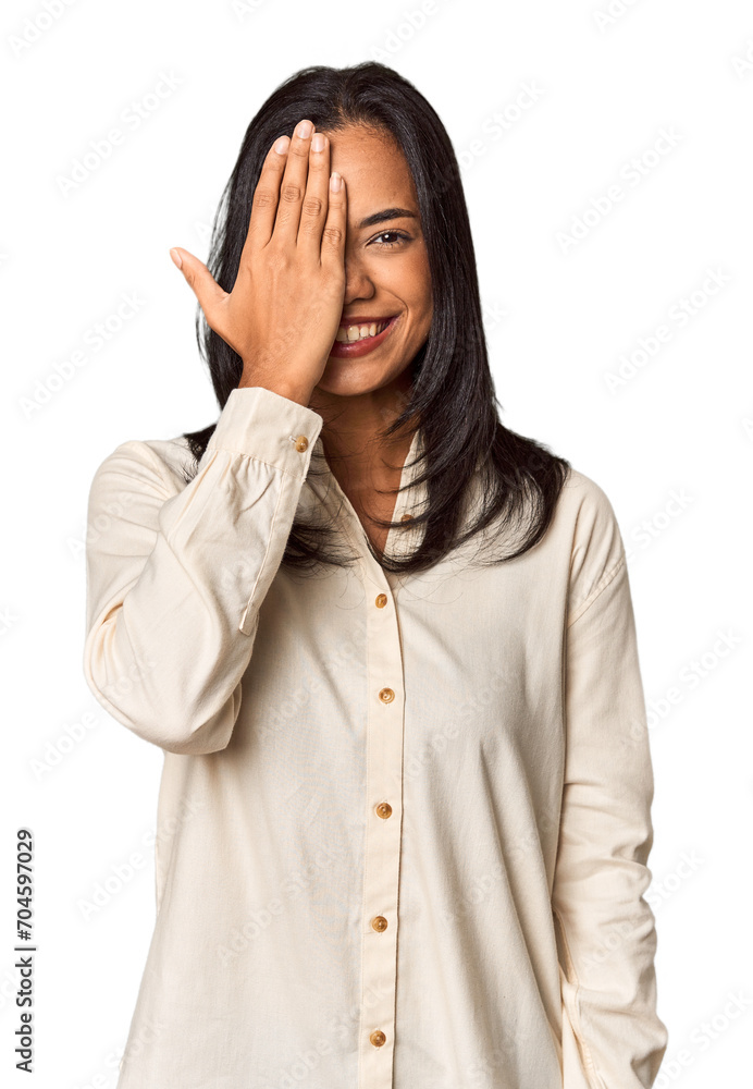 Young Filipina with long black hair in studio having fun covering half of face with palm. Young Filipina with long black hair in studio having fun covering half of face with palm.