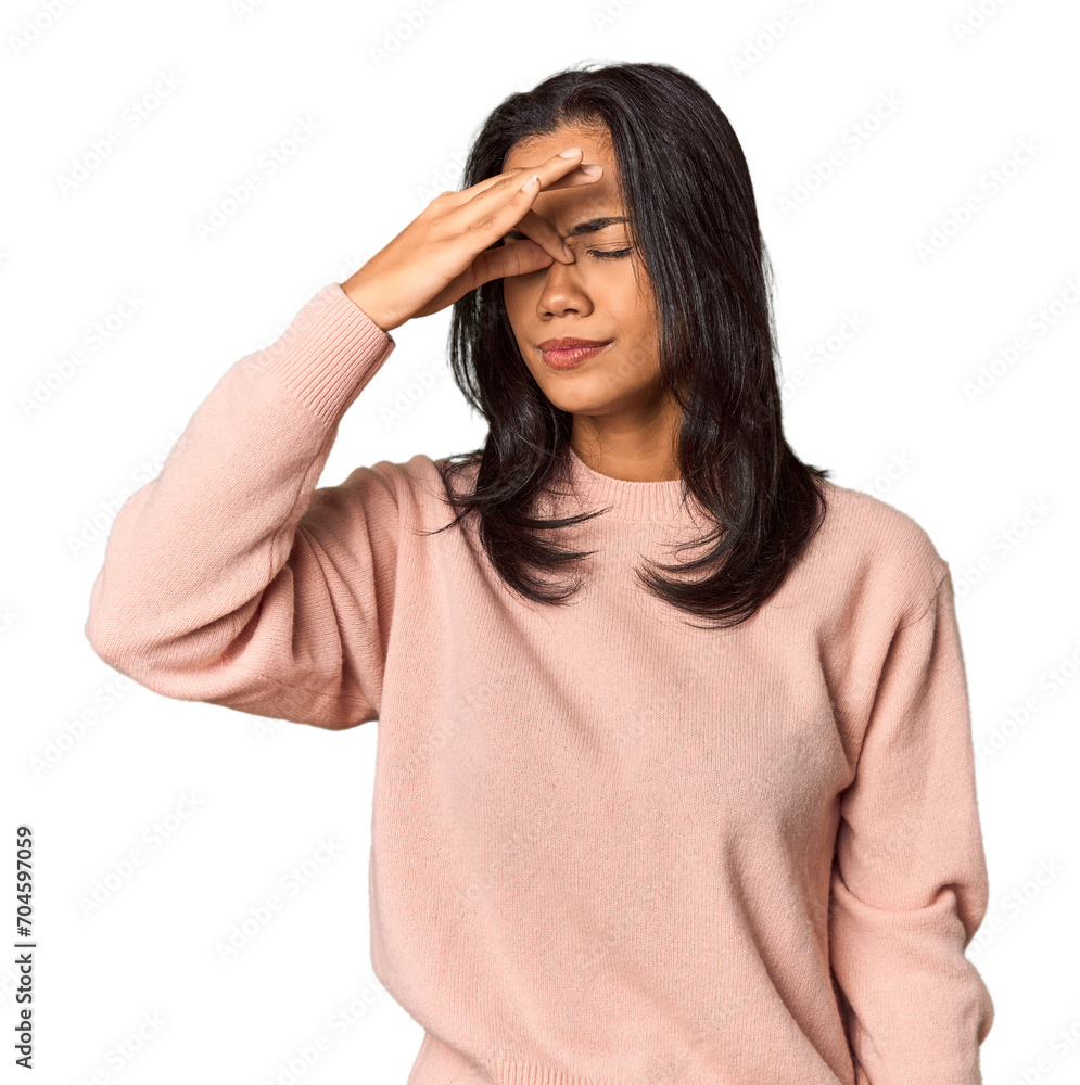 Young Filipina with long black hair in studio having a head ache, touching front of the face. Young Filipina with long black hair in studio having a head ache, touching front of the face.