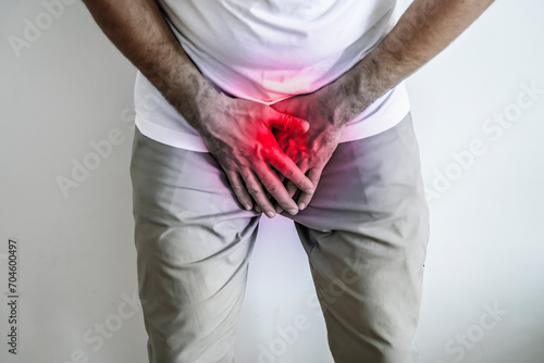 Pain in the groin and urination. Men's health and medicine concept. photo