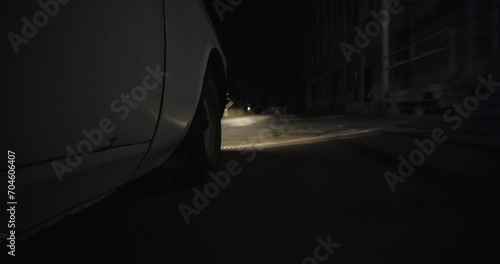 Poor Neighborhood Of Row Homes. Old Car during night. Crime abandoned area.  photo