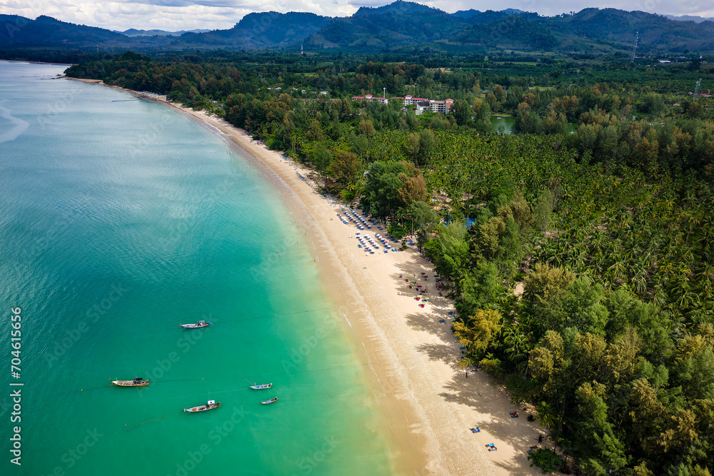 Aerial view of traditional boats along a beautiful, sandy tropical beach (Khao Lak, Thailand)