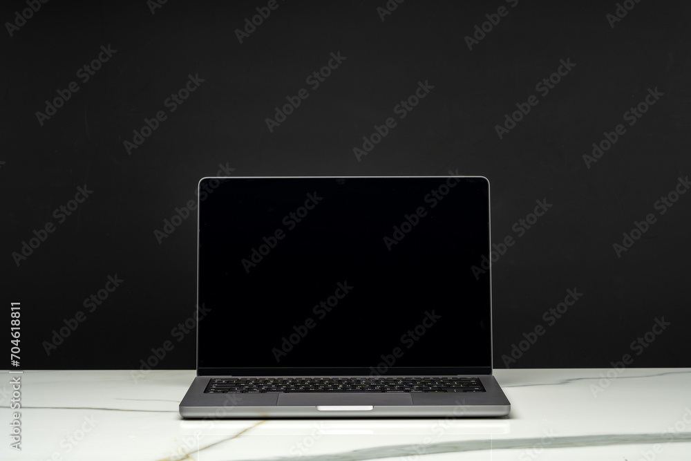 Open laptop with black screen against black background Open laptop with black screen against black background