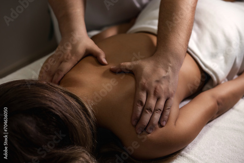 Chiropractor masseur doing exam back of lady  rehabilitation massage in medic room  healthy lifestyle. Rehab massage back for woman at clinic. Wellness medicine massaging concept. Copy ad text space