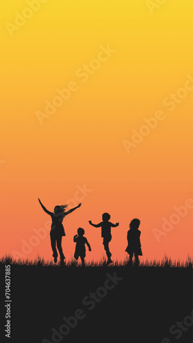 The silhouette of joyful children playing on grass against a vibrant orange sunset, capturing the essence of childhood and the end of a fun-filled day. photo