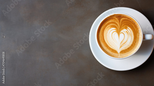 Coffee cup with latte art on wooden table.