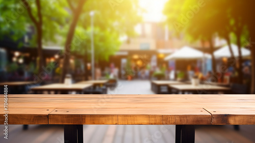 Outdoor table at a cafe, empty wooden table for packshot and studio, street food, farmer's market, eating outside at a restaurant