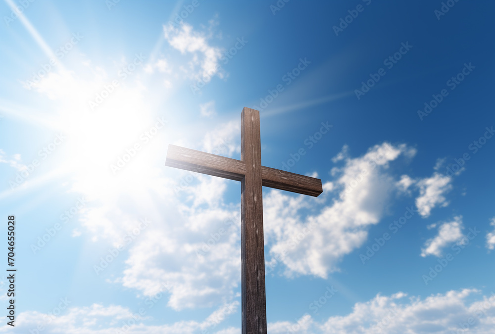 A wooden cross standing on a blue sky with sunlight