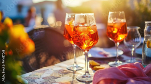 Glasses of Aperol Spritz cocktail on restaurant table served outside