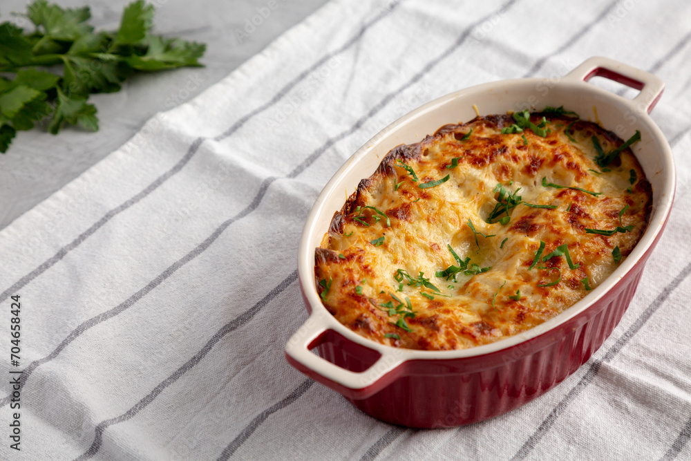 Homemade Scalloped Potatoes with Cheese and Parley, side view. Homemade Scalloped Potatoes with Cheese and Parley, side view.