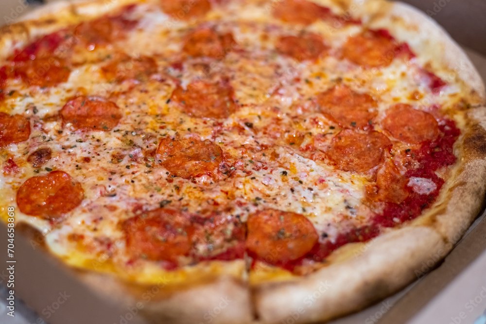 Large pizza cut into pieces, close-up. Selective focus Large pizza cut into pieces, close-up. Selective focus