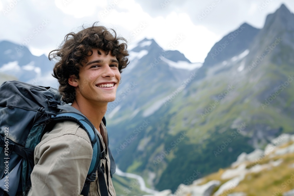 Smiling young man with a backpack on an exciting mountain adventure