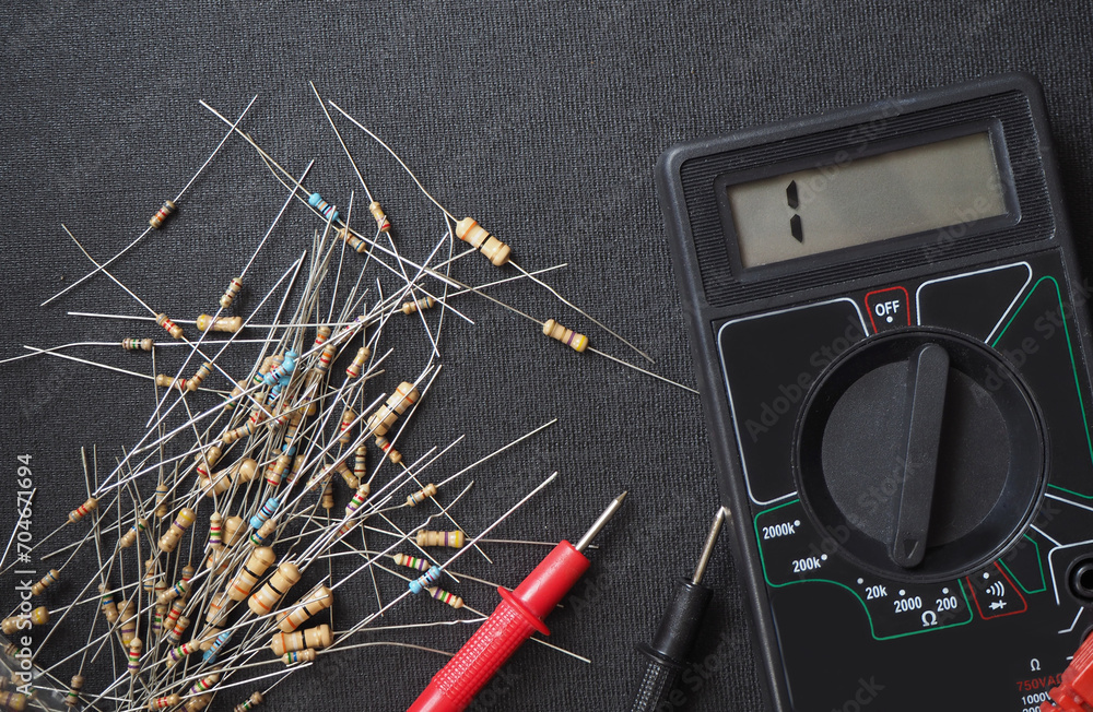 Electrical resistors and ohmmeter on the workbench. Electrical resistors and ohmmeter on the workbench.