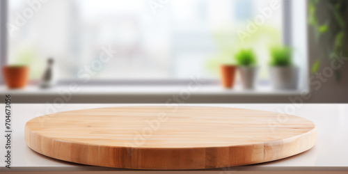 Round wooden table on blurred kitchen background photo