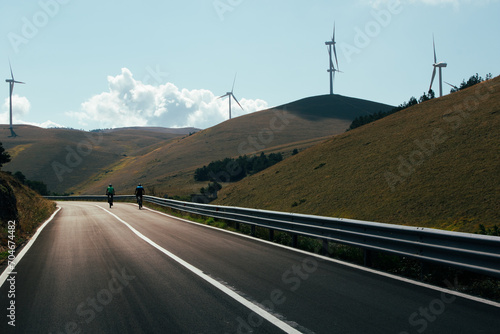 A wind farm or wind park at sunset located in the mountains of Italy Europe and it allows to realize clean energy. It’s sustainable, renewable energy for enviromental. Nature sky background positive