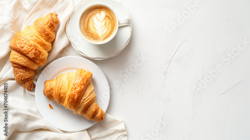 Two Croissants and a Cup of Coffee on a White Table