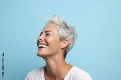 Portrait of a beautiful woman with short white hair on a blue background