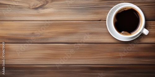 Empty cup of coffee or tea, mockup with hot beverage on wooden table background (top view)