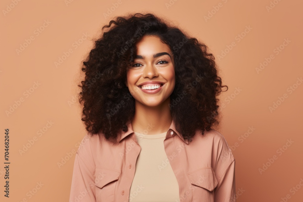 Happy african american woman with curly hair smiling at camera. Happy african american woman with curly hair smiling at camera.