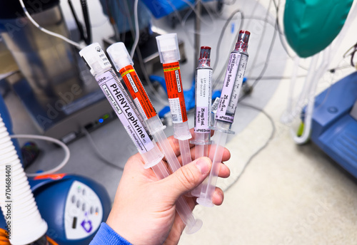 Medical vials, syringes, and needles representing hospital drugs and medications for anesthesia and sedation in healthcare settings