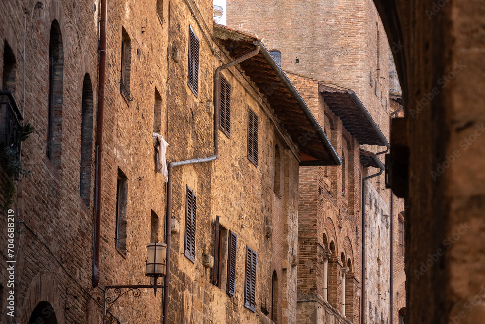 Facade of typical medieval residential houses in downtown San Gimignano