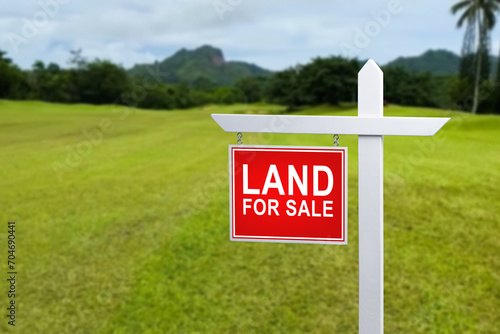 land for sale plate sign, green lawn background. photo