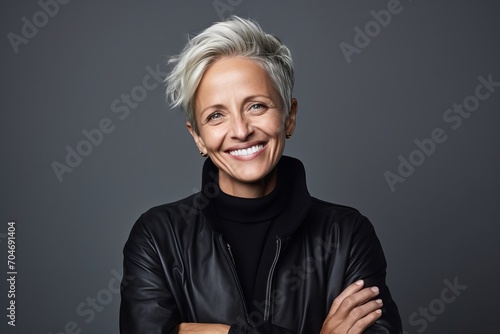 Mature woman in a black leather jacket. Portrait of a happy mature woman in a black leather jacket.