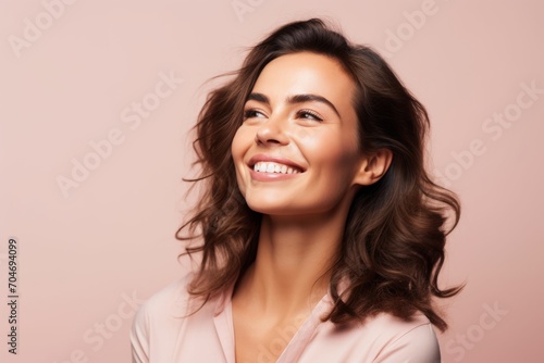 Portrait of happy smiling beautiful young woman, over pink background.