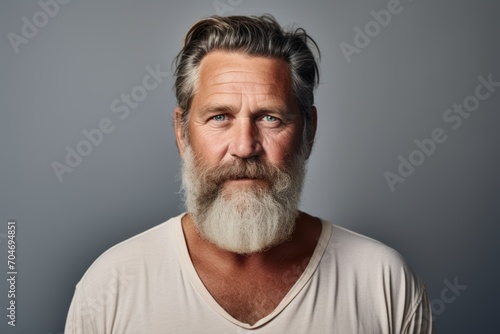 Portrait of a handsome mature man with grey beard and mustache.